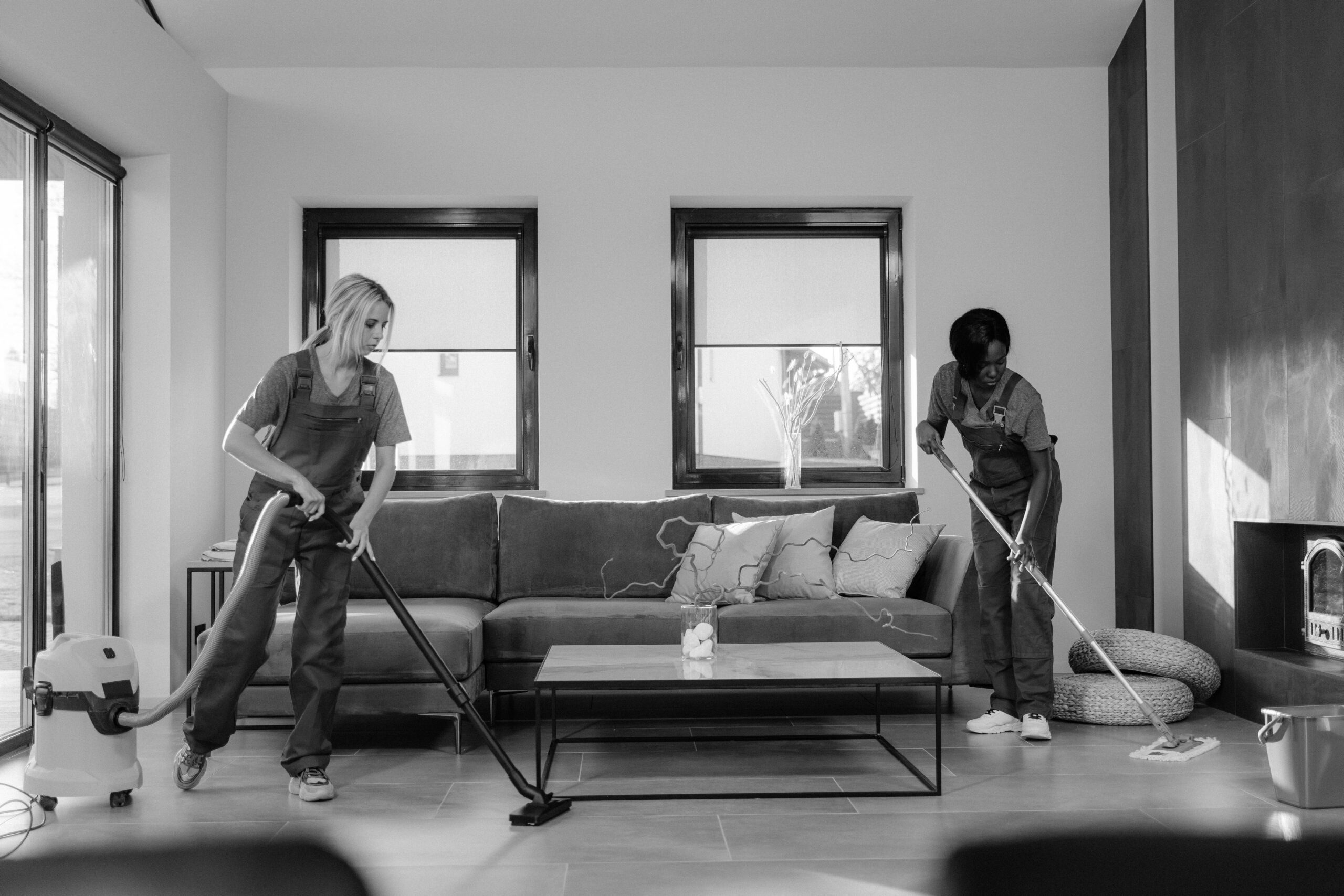 Professional cleaning team working together in a living room